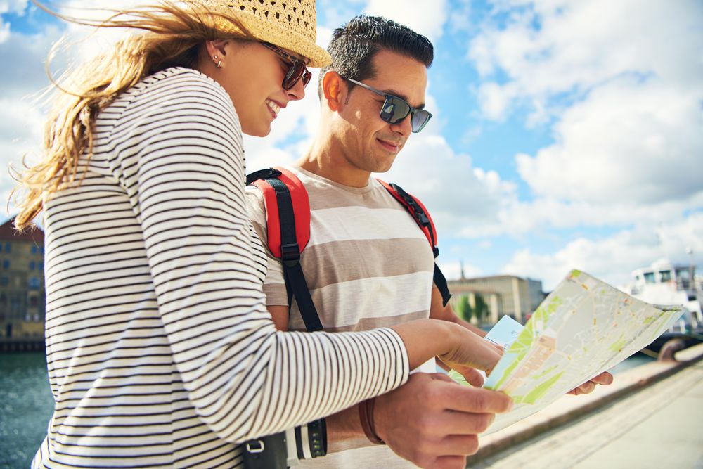 Couple on holiday checking a map for directions