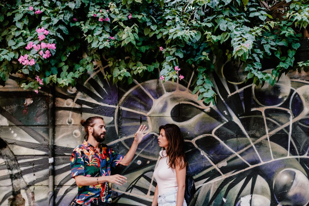 Casual friends against wall with graffiti