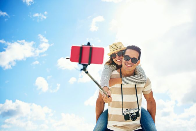 Tourist couple taking picture with selfie stick