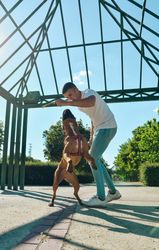 Man running and playing with his dog.