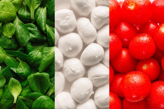 Flag of Italy made of basil leaves, mozzarella cheese, and cherry tomatoes