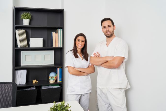 portrait of two physiotherapists in their clinic looking at the