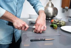 Man chopping onion with knife