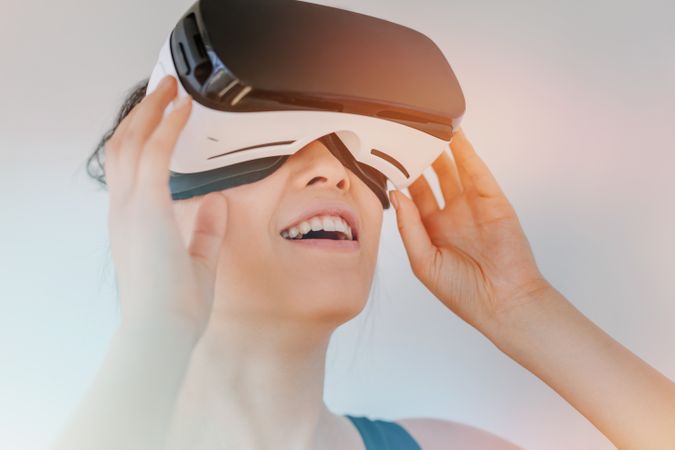 Close up of young woman in virtual reality headset looking at the objects