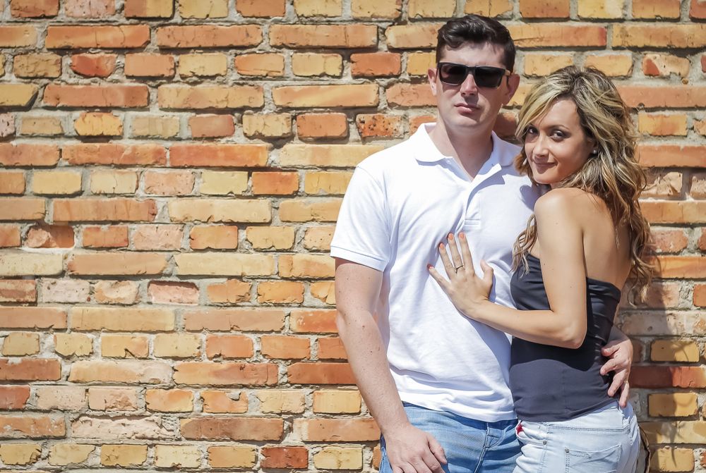 Couple portrait in front of brick wall