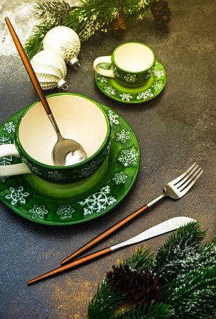 Two green mugs with snowflake pattern