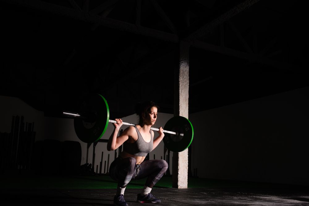 Woman lifting barbell in gym