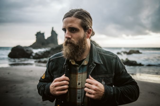 Bearded man standing near sea