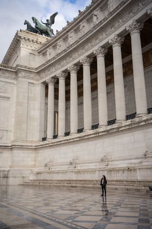 Tourist standing near old building with columns