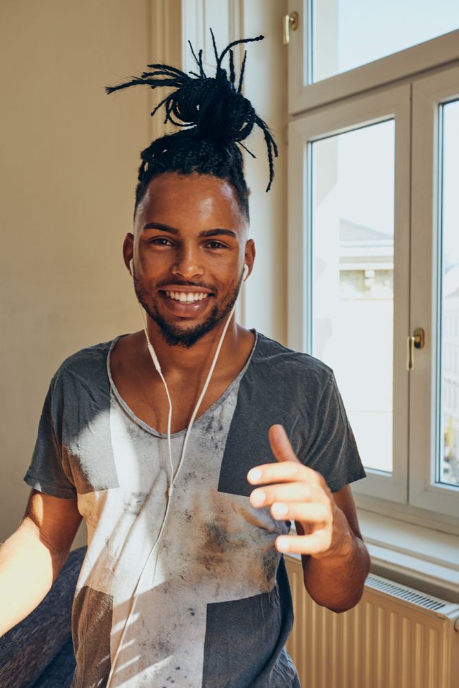 Cheerful Black male listening to music