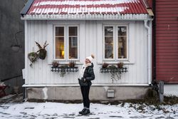 Cheerful female against northern house