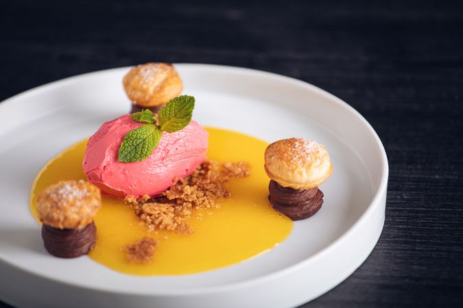 Raspberry ice cream with curable oranges chocolate and puff pastry