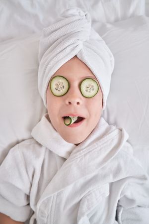 Child relaxing during spa procedures at home