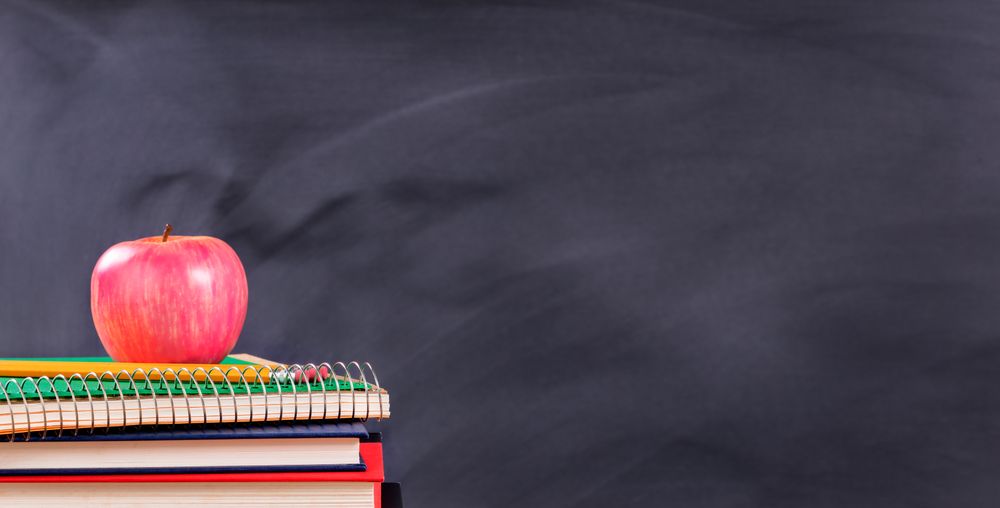 Back to school materials in front of chalkboard