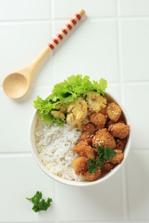 Top View Takeaway Rice Bowl with Chicken Popcorn and Scrambled Egg