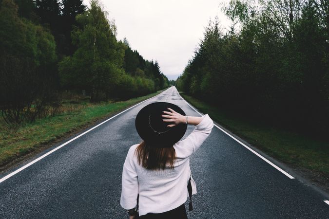 Stylish woman on remote empty road