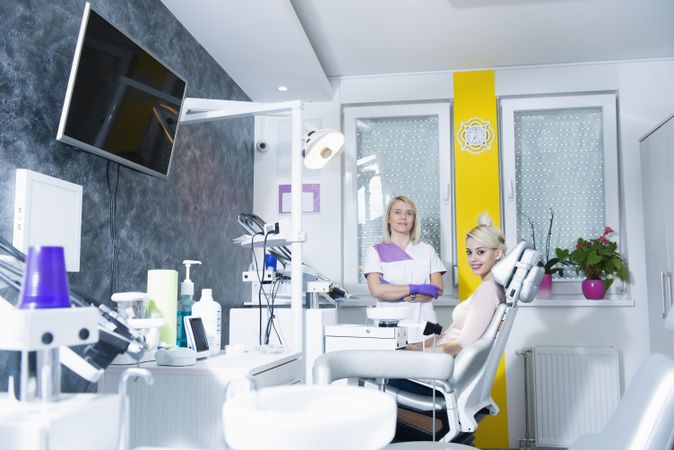 Dentist with patient sitting in chair