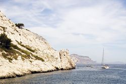 Limestone rocks and boats sailing in sea