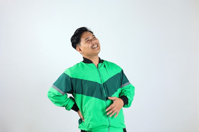 Adult Asian Indonesian Man Touching his Belly with Relieved Expression