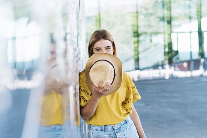 Woman with blue eyes holding straw hat