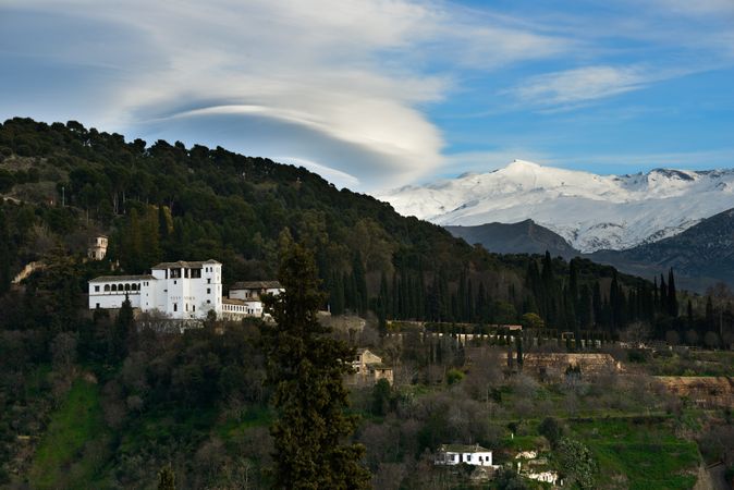 Alhambra and snow in the Sierra Nevada mountains under a lenticular cloud