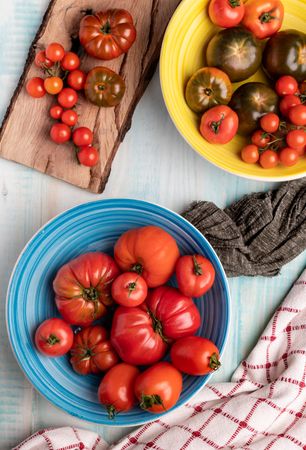 Napkins near bowls and board with tomatoes