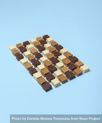 Homemade fudge pieces aligned over a blue background 4BLJx0