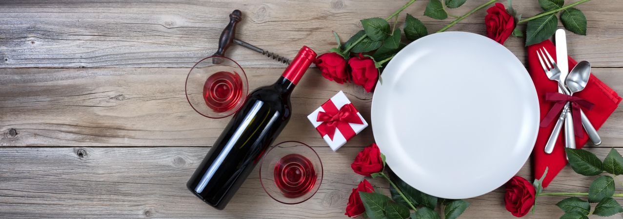 Valentine’s dinner with red wine on rustic wood