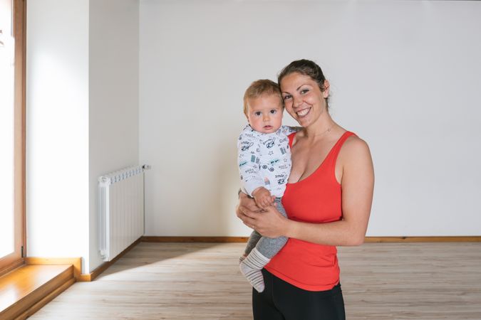 Woman holding baby in gym