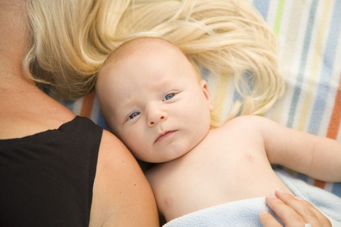 Cute Baby Boy Laying Next to His Mommy on Blanket