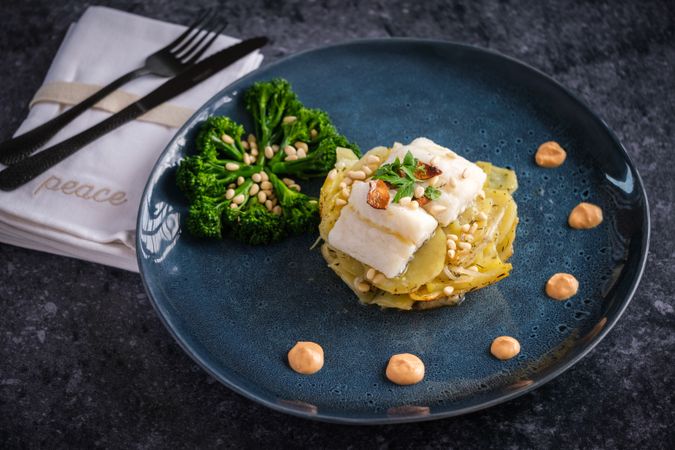 Delicious gratin with fish served with broccoli and sauce