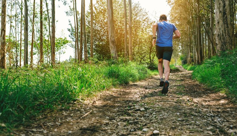 Unrecognizable man participating in trail race