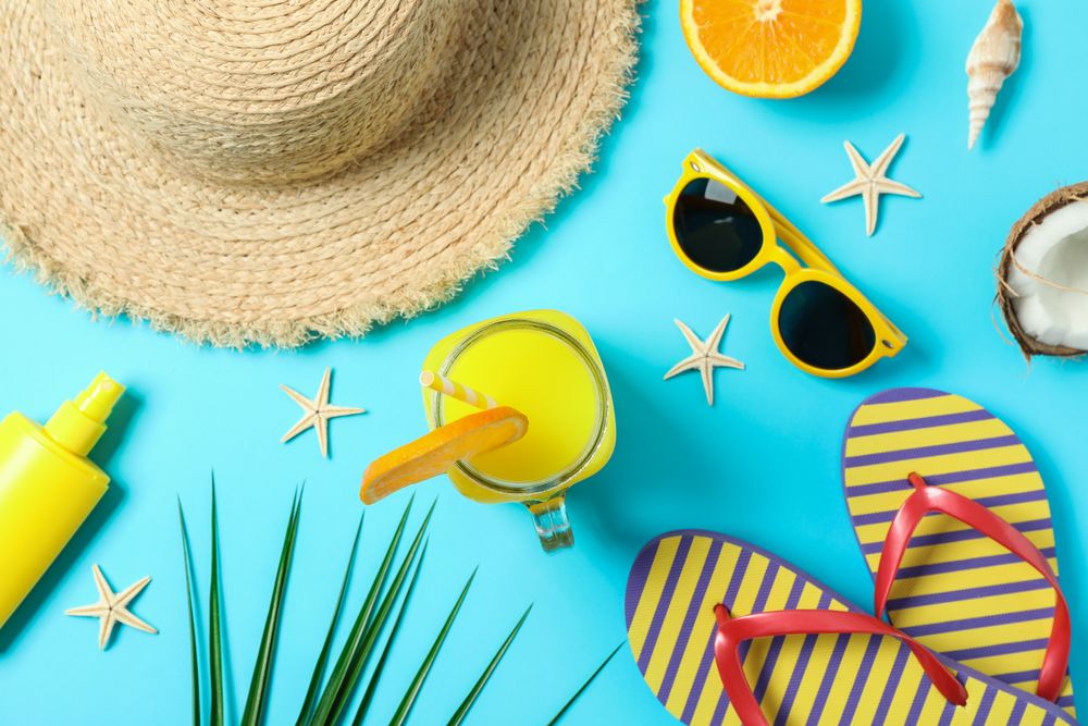Flat lay composition with summer vacation accessories on color background, closeup and top view. Happy holidays