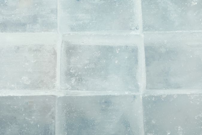 Top view, close up of rows of tightly stacked square ice cubes