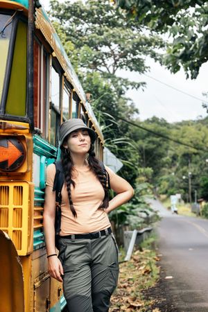 Woman leaning on a vintage school bus