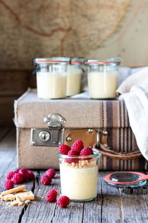 Cheesecake with raspberry in tubs on table