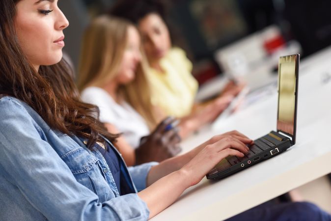 Side view of woman working on her laptop