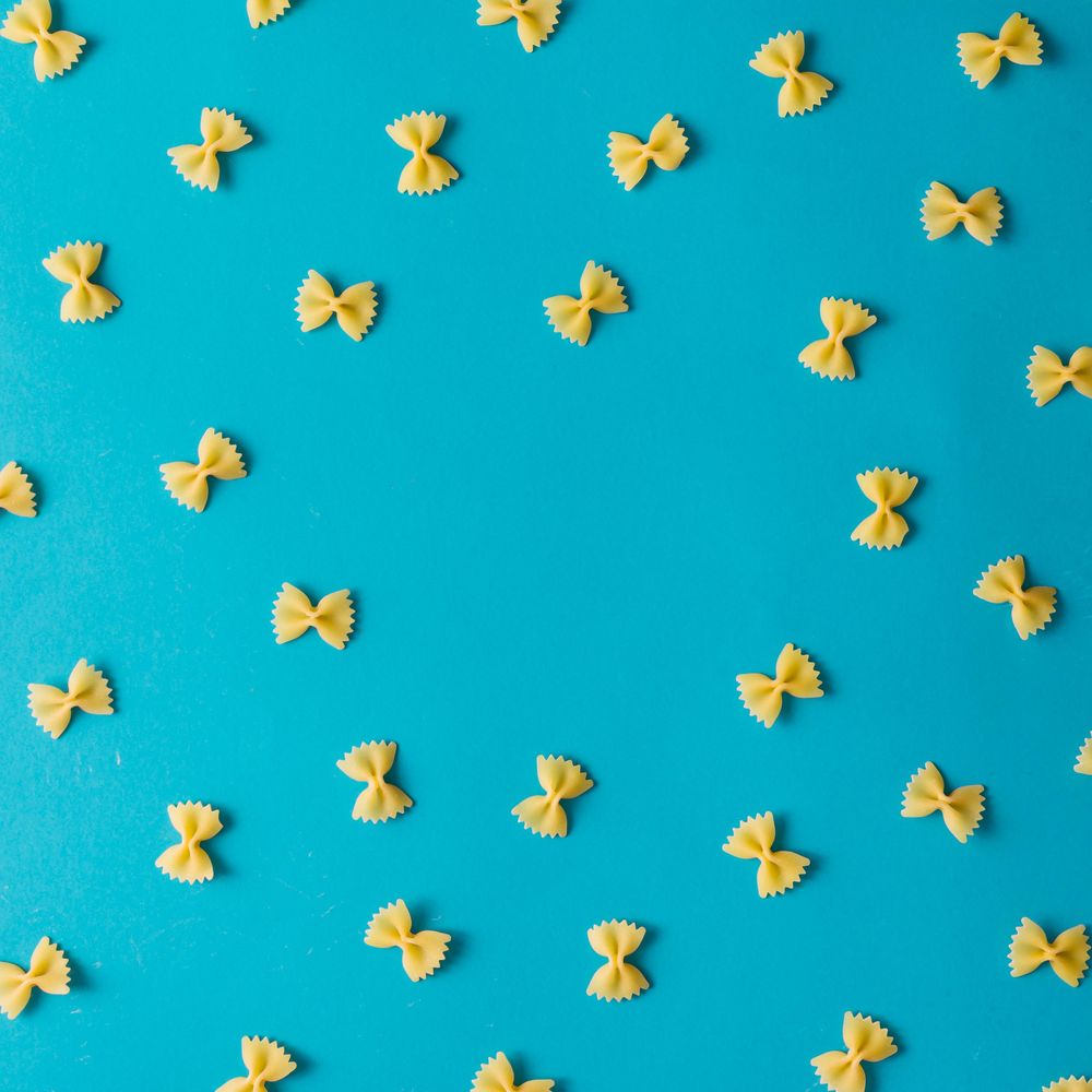 Pattern made of pasta on blue background