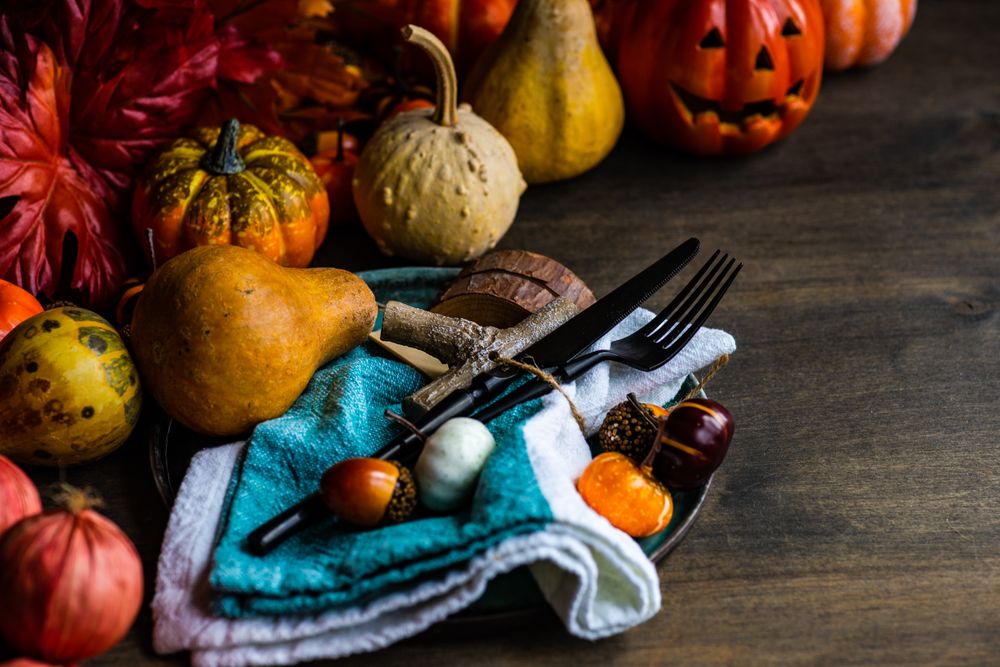 Autumnal decorations of squash and gourds on table