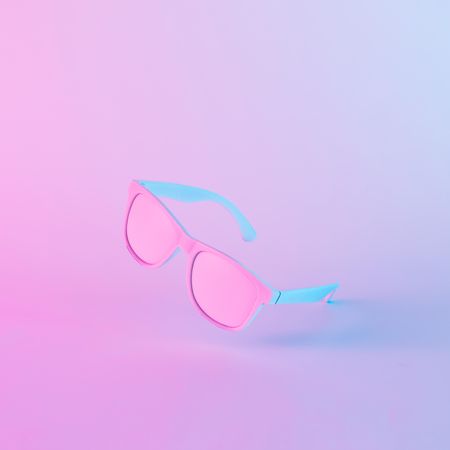 Sunglasses in vibrant bold gradient purple and blue holographic colors