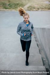 Fitness woman doing running exercise on stair 49m6ZB