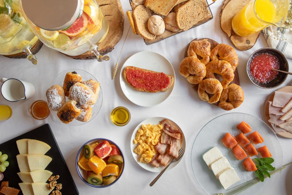 Assorted food table with baked products seafood fruit juices