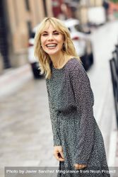 Carefree blonde woman standing in Spanish street bxB3a5