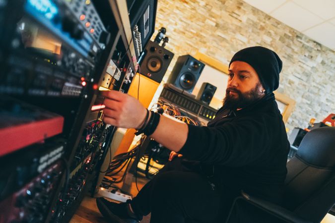 Man adjusting sound control in a studio