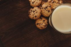 Savoring Simplicity: Homemade Cookies with a Glass of Milk on an Elegant Wooden Table.