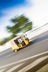 Fast driving three wheeler on road