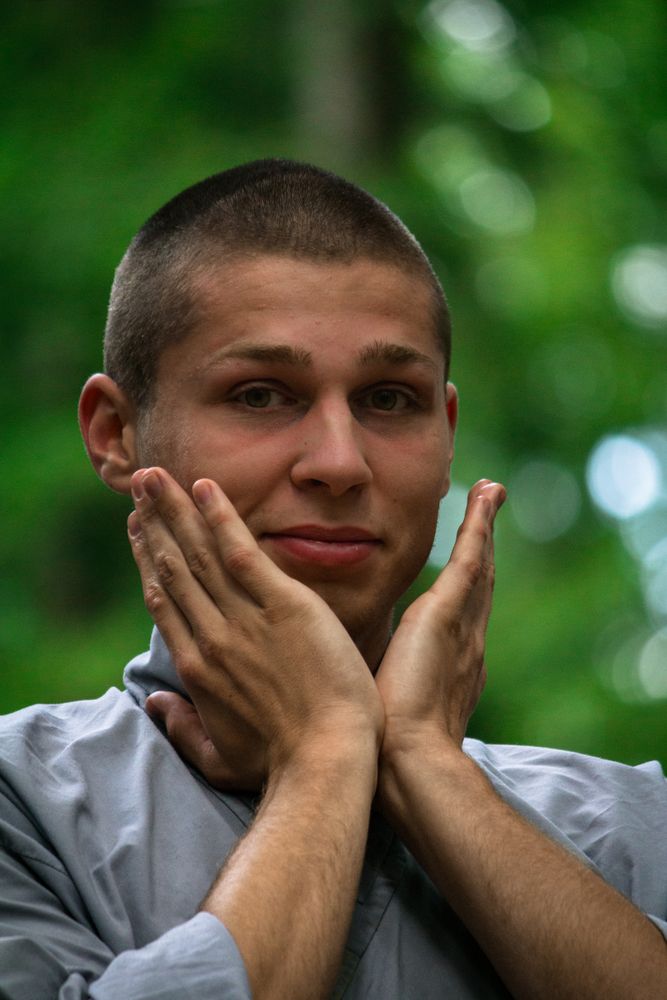 Young man meditating in garden