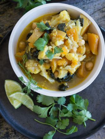 Plate with vegetarian curry on tray