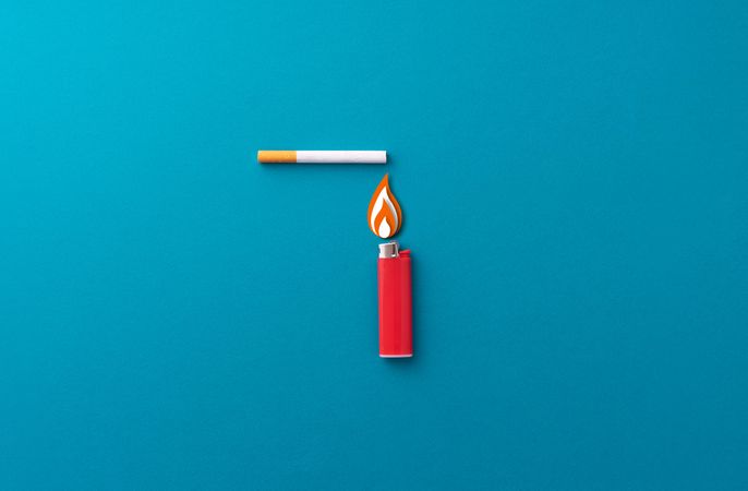 One red lighter and one cigarette on blue background