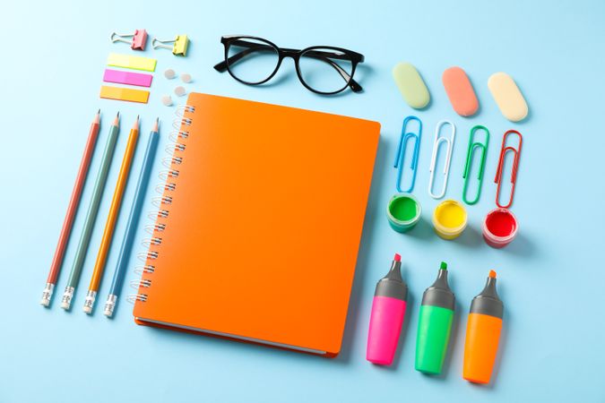 Flat lay composition with school supplies on color background, space for text